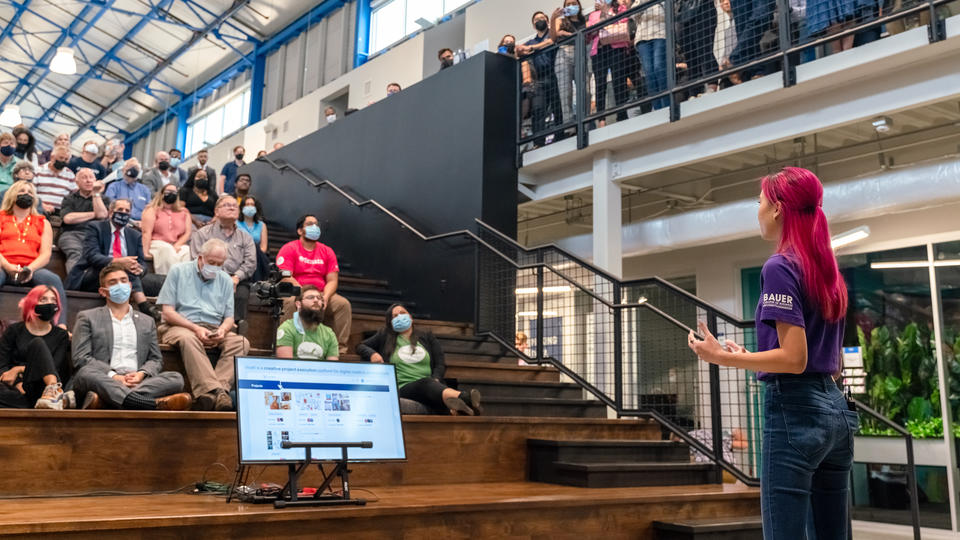 Student pitching to a room of people