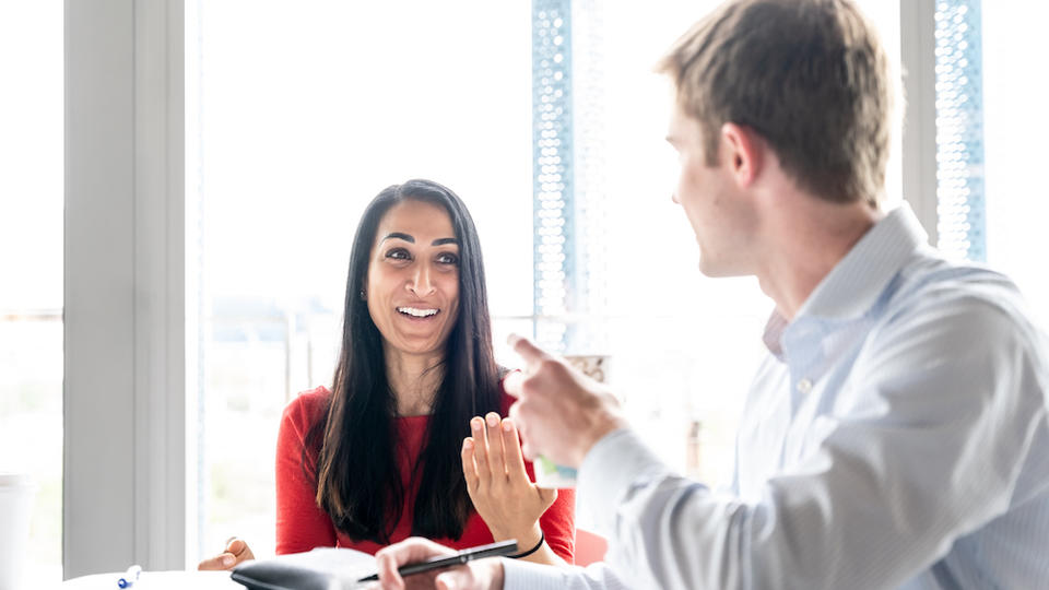 Two People Talking at a Table