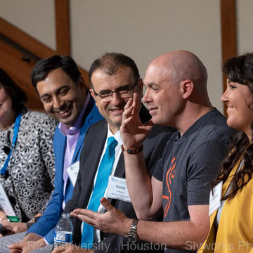 People speaking on a panel 